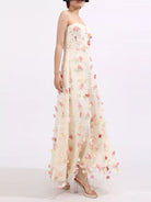 NEWYORKLISTED STYLE COLLECTION: Woman wearing a strapless floral gown on a white background