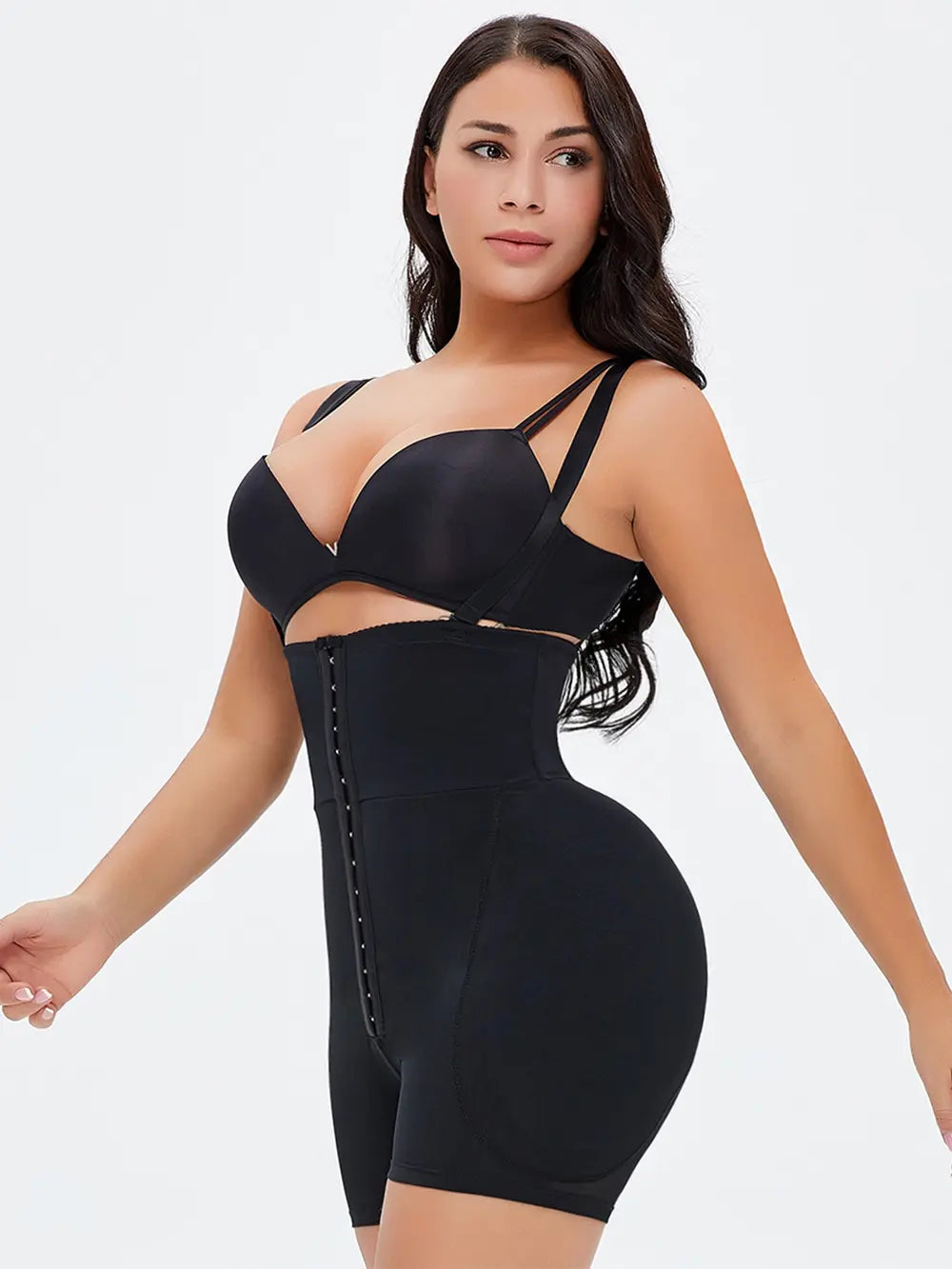 NEWYORKLISTED Intimate Apparel: Woman wearing a black shapewear bodysuit on a white background
