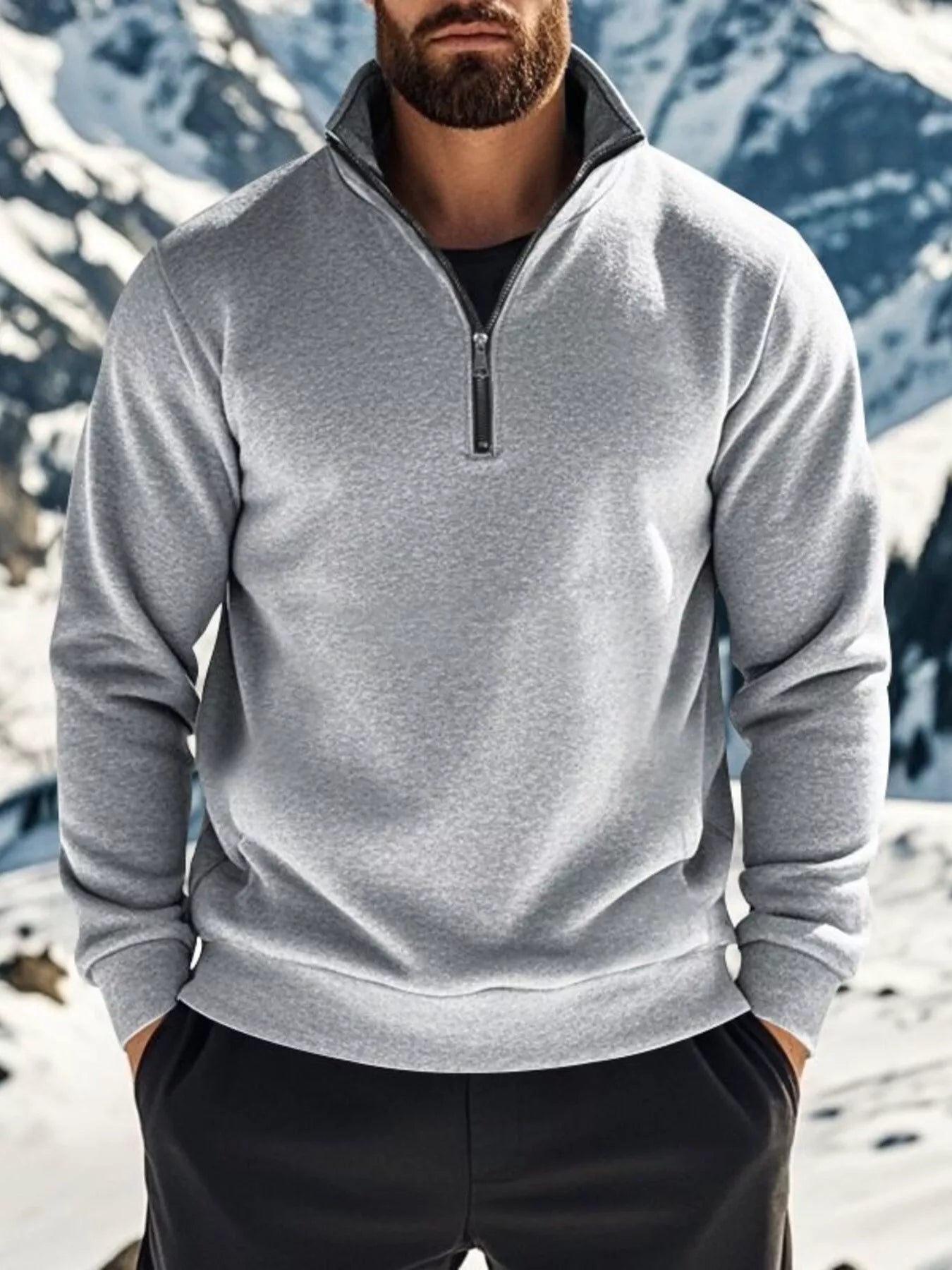 NEWYORKLISTED ATLAS MEN'S COLLECTION: Person wearing a gray pullover with a mountainous background