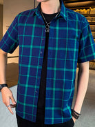 NEWYORKLISTED ATLAS MEN'S COLLECTION: Person wearing a blue and green checkered shirt indoors.