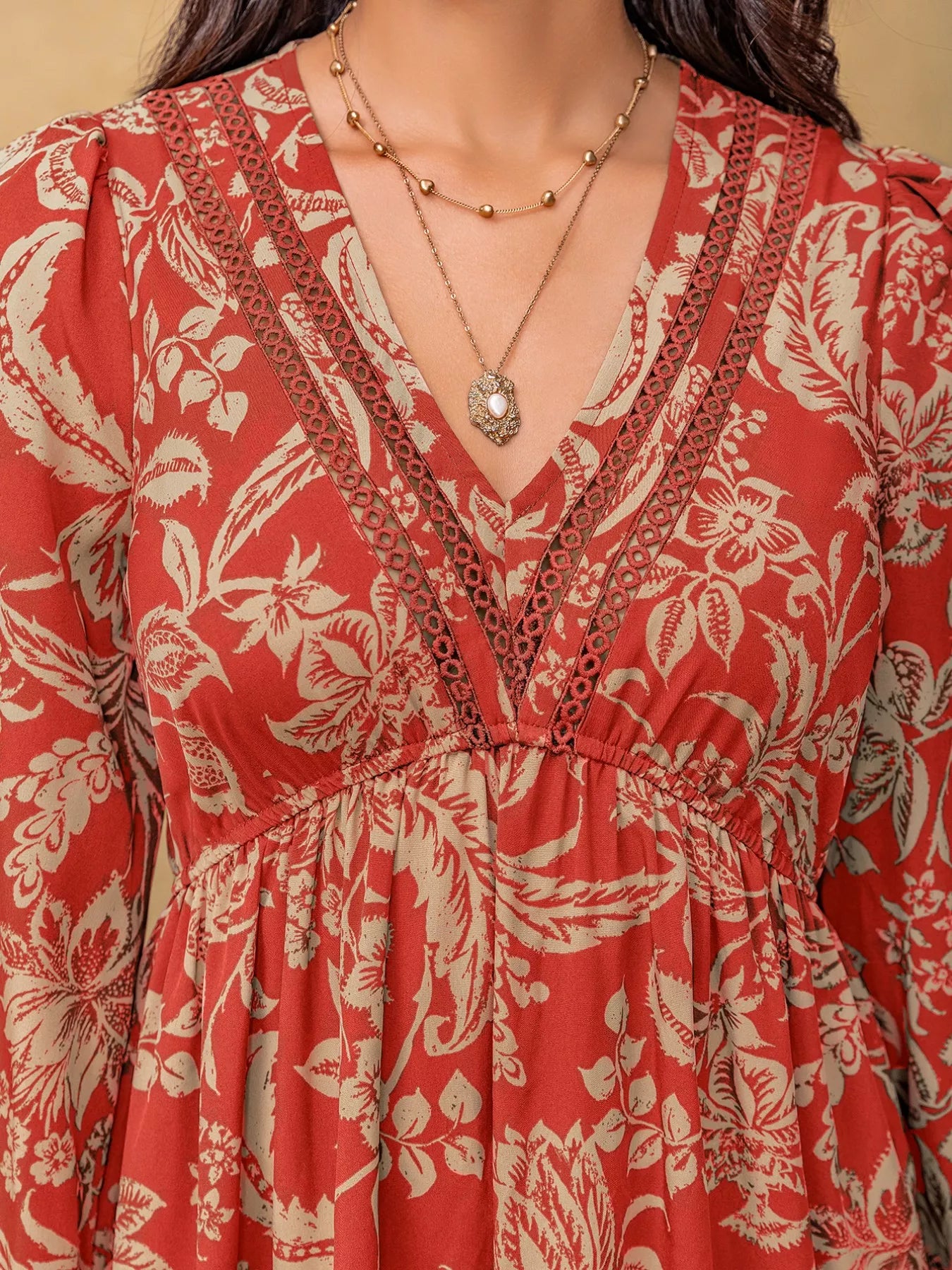 NEWYORKLISTED STYLE COLLECTION: Red floral dress with a necklace on a neutral background