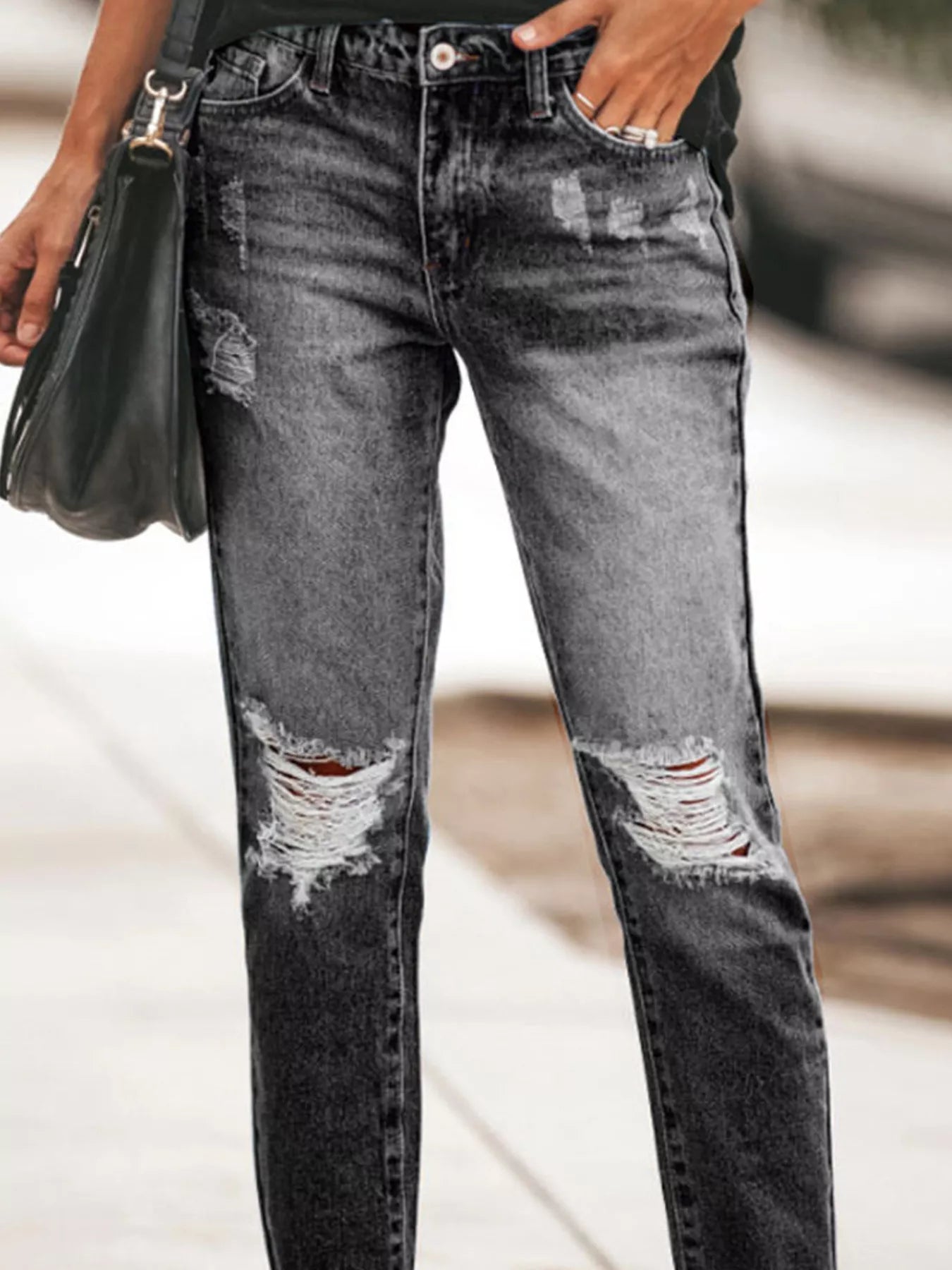NEWYORKLISTED STYLE COLLECTION: Person wearing distressed black jeans with a blurred background