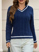 NEWYORKLISTED STYLE COLLECTION: Woman wearing a blue cable knit sweater with white trim.