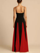 NEWYORKLISTED STYLE COLLECTION: Woman wearing a black and red dress with a plain background
