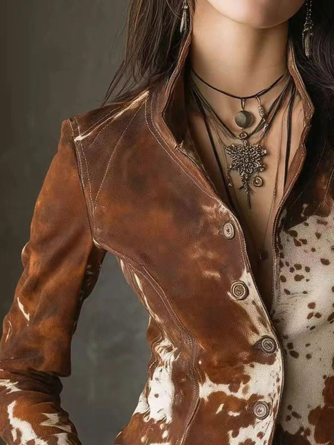 NEWYORKLISTED STYLE COLLECTION: Close-up of a person wearing a brown leather jacket with a dark background