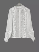 NEWYORKLISTED STYLE COLLECTION: White lace blouse on a hanger against a gray background