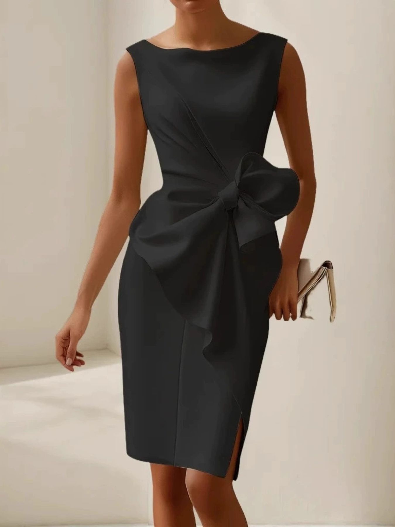 NEWYORKLISTED STYLE COLLECTION: Black dress with a large bow detail on a neutral background