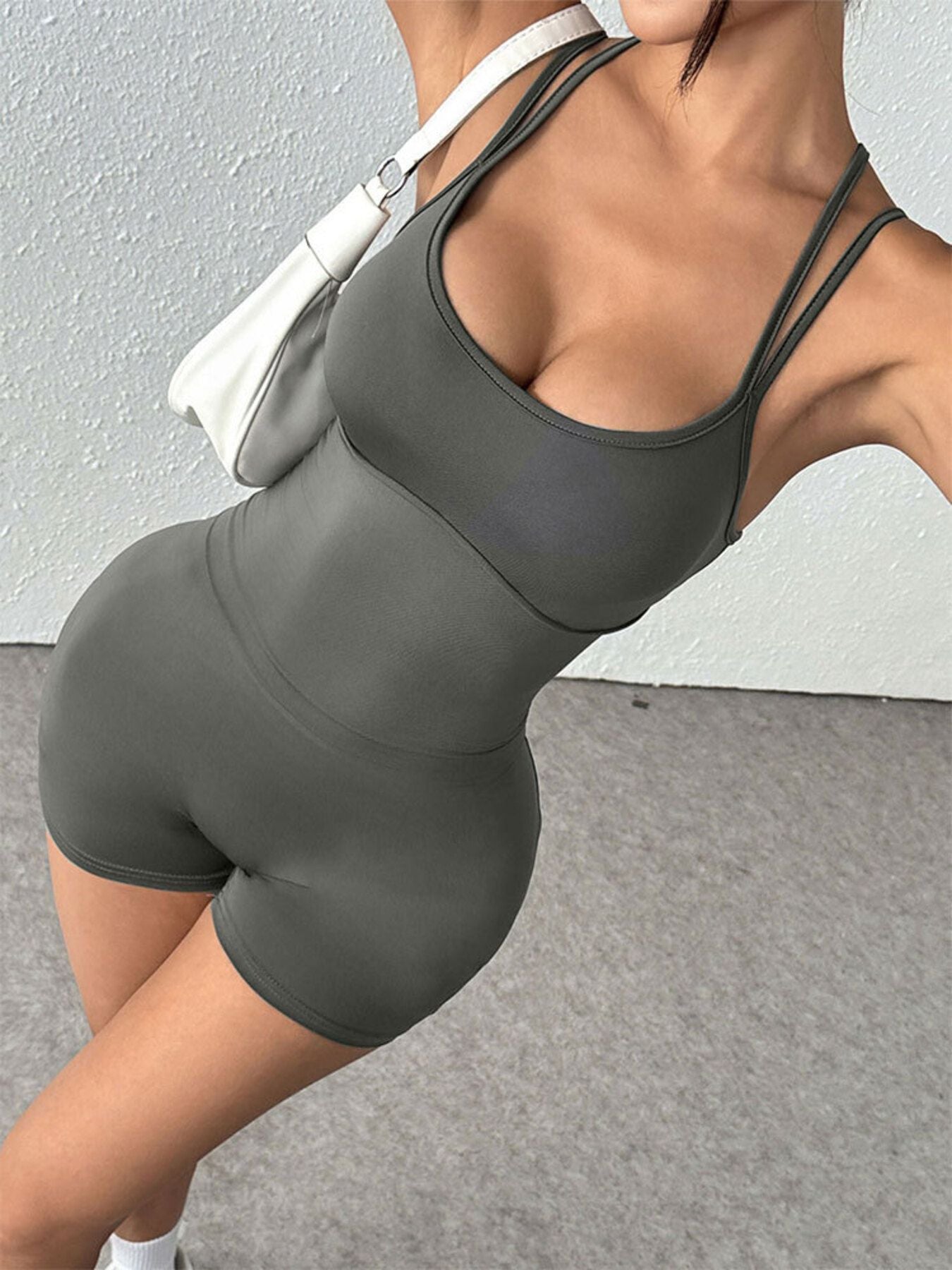 Person wearing a gray athletic outfit against a neutral background