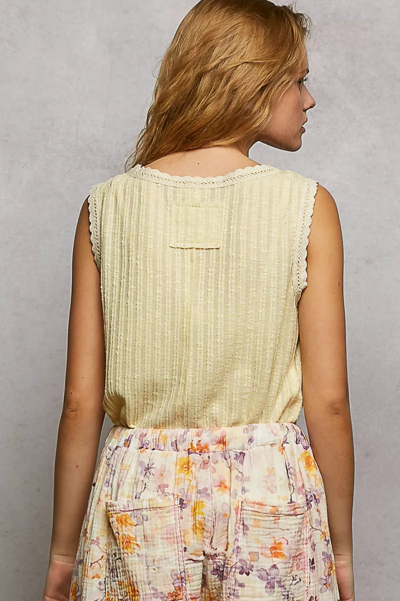 NEWYORKLISTED STYLE COLLECTION: Woman wearing a light green sleeveless top and floral skirt against a gray background