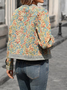 NEWYORKLISTED STYLE COLLECTION: Person wearing a floral patterned jacket on a city street.