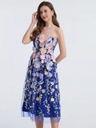 NEWYORKLISTED STYLE COLLECTION: Woman wearing a strapless floral dress on a white background