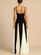 NEWYORKLISTED STYLE COLLECTION: Woman wearing a black and white jumpsuit on a beige background