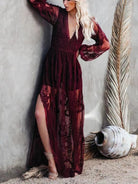 NEWYORKLISTED STYLE COLLECTION: Woman wearing a burgundy lace dress against a textured wall.