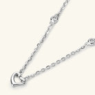 NEWYORKLISTED Valentine’s Day Specials: Silver necklace with a heart pendant on a white background