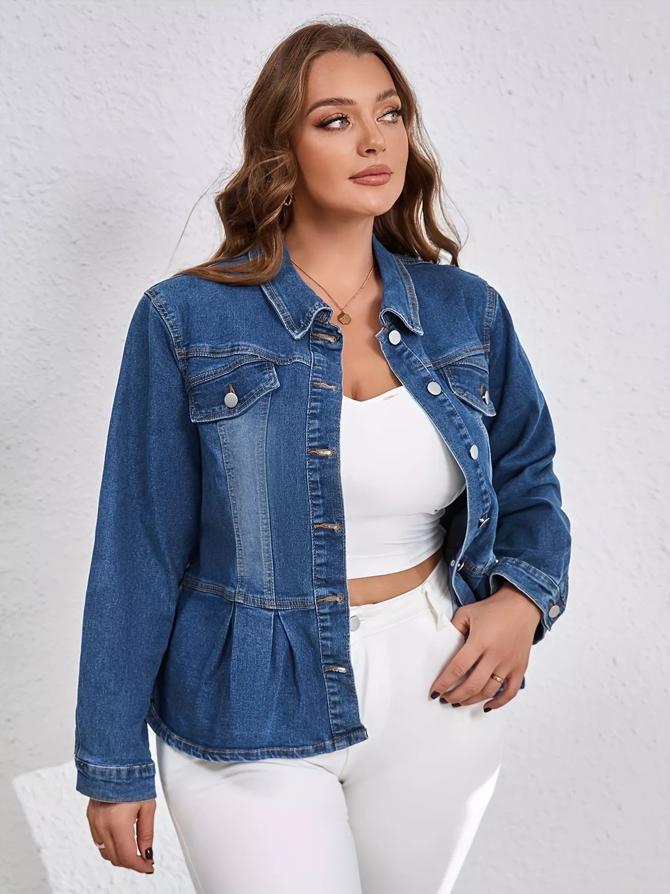 NEWYORKLISTED STYLE COLLECTION: Woman wearing a blue denim jacket over a white top and pants on a light gray background