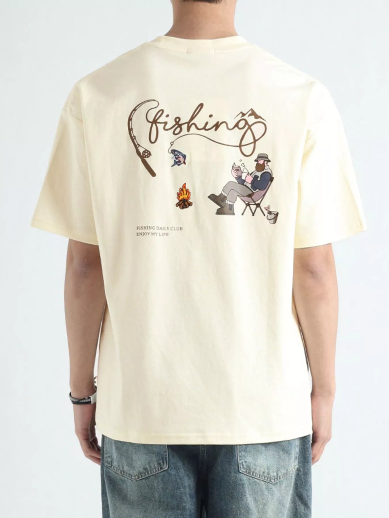 Beige t-shirt with fishing-themed graphics and text on a white background