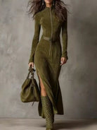NEWYORKLISTED STYLE COLLECTION: Woman wearing a green dress and boots holding a matching handbag against a gray background