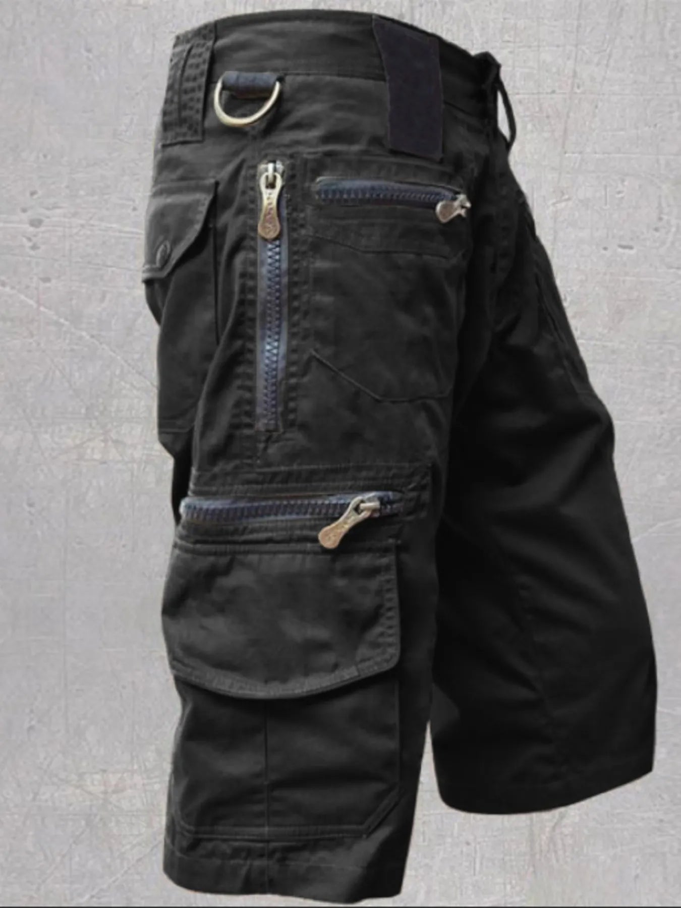 NEWYORKLISTED ATLAS MEN'S COLLECTION: Black tactical shorts with multiple pockets and zippers on a gray background