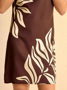 NEWYORKLISTED STYLE COLLECTION: Brown dress with white leaf pattern on a beige background