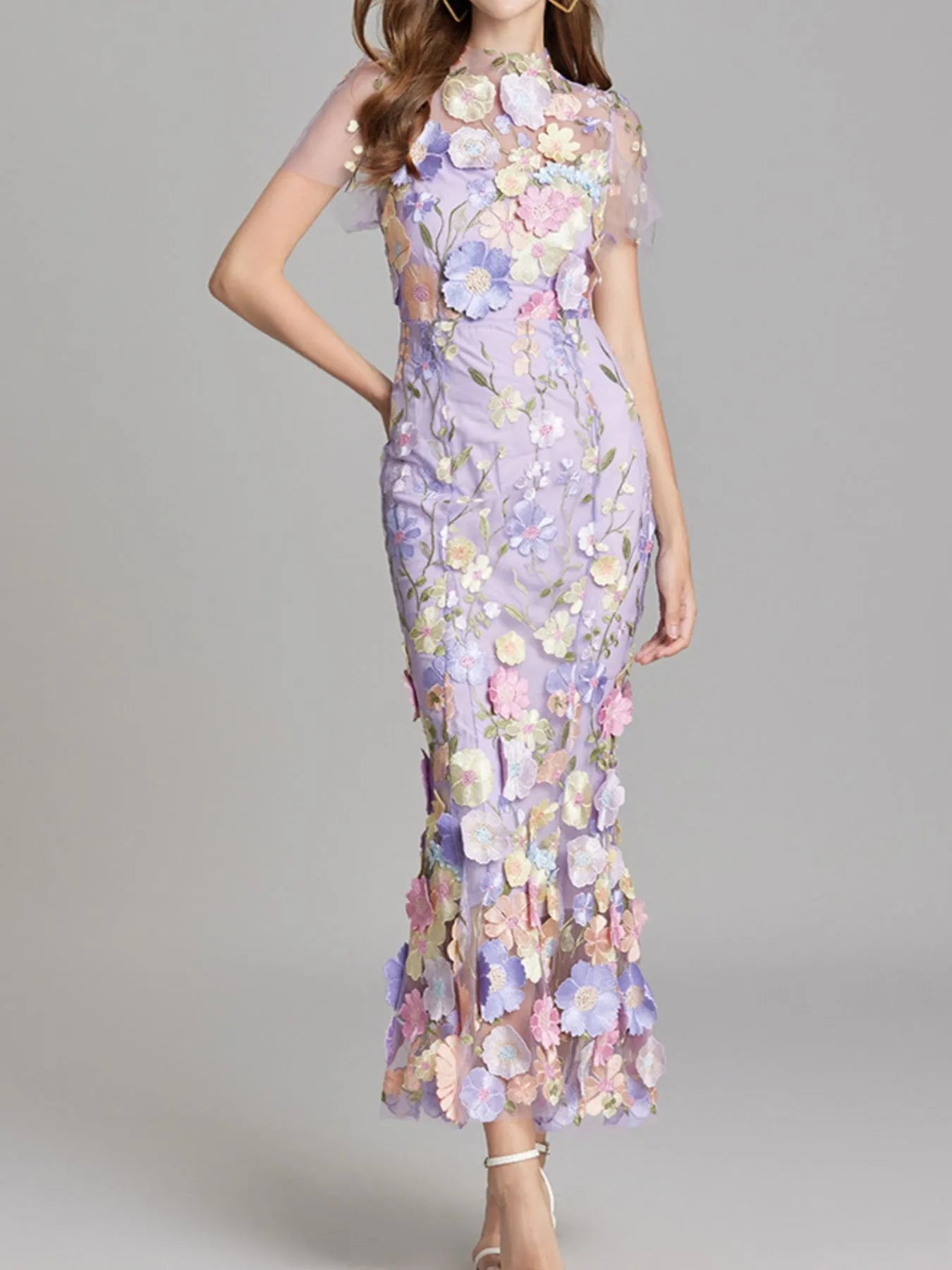 NEWYORKLISTED STYLE COLLECTION: Woman wearing a floral dress with a gray background