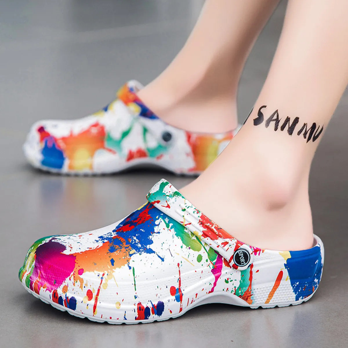 NEWYORKLISTED STYLE COLLECTION: Colorful splatter paint clogs worn by a person on a gray background