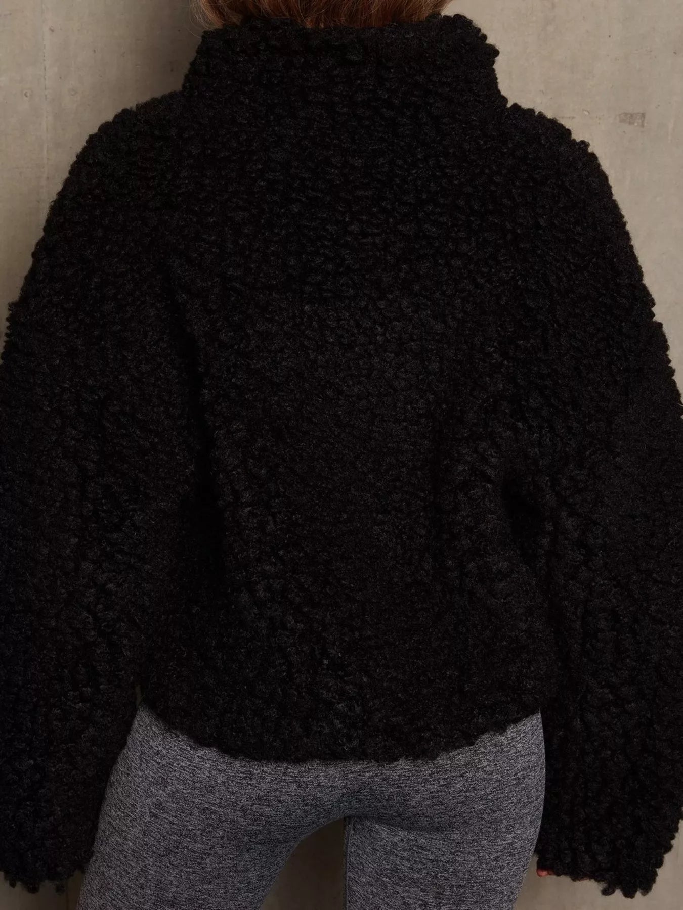 NEWYORKLISTED STYLE COLLECTION: Black textured jacket worn by a person against a neutral background