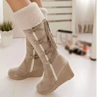 NEWYORKLISTED SHOE COLLECTION: Beige wedge boots with white fur lining worn indoors.