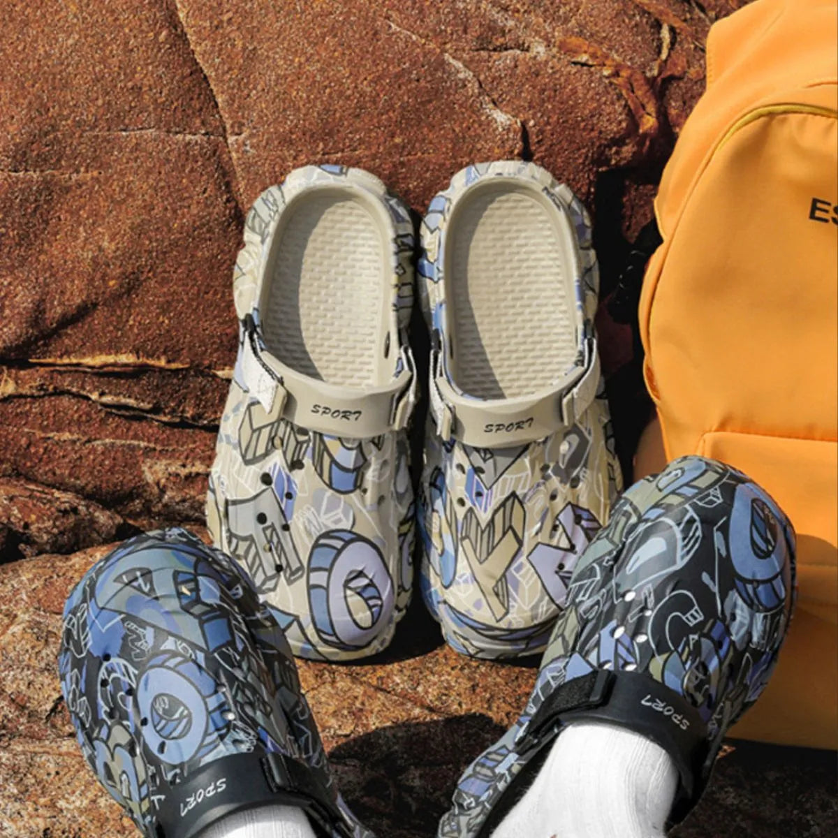 NEWYORKLISTED ATLAS MEN'S COLLECTION: Pair of patterned sandals and matching leggings on a rocky surface