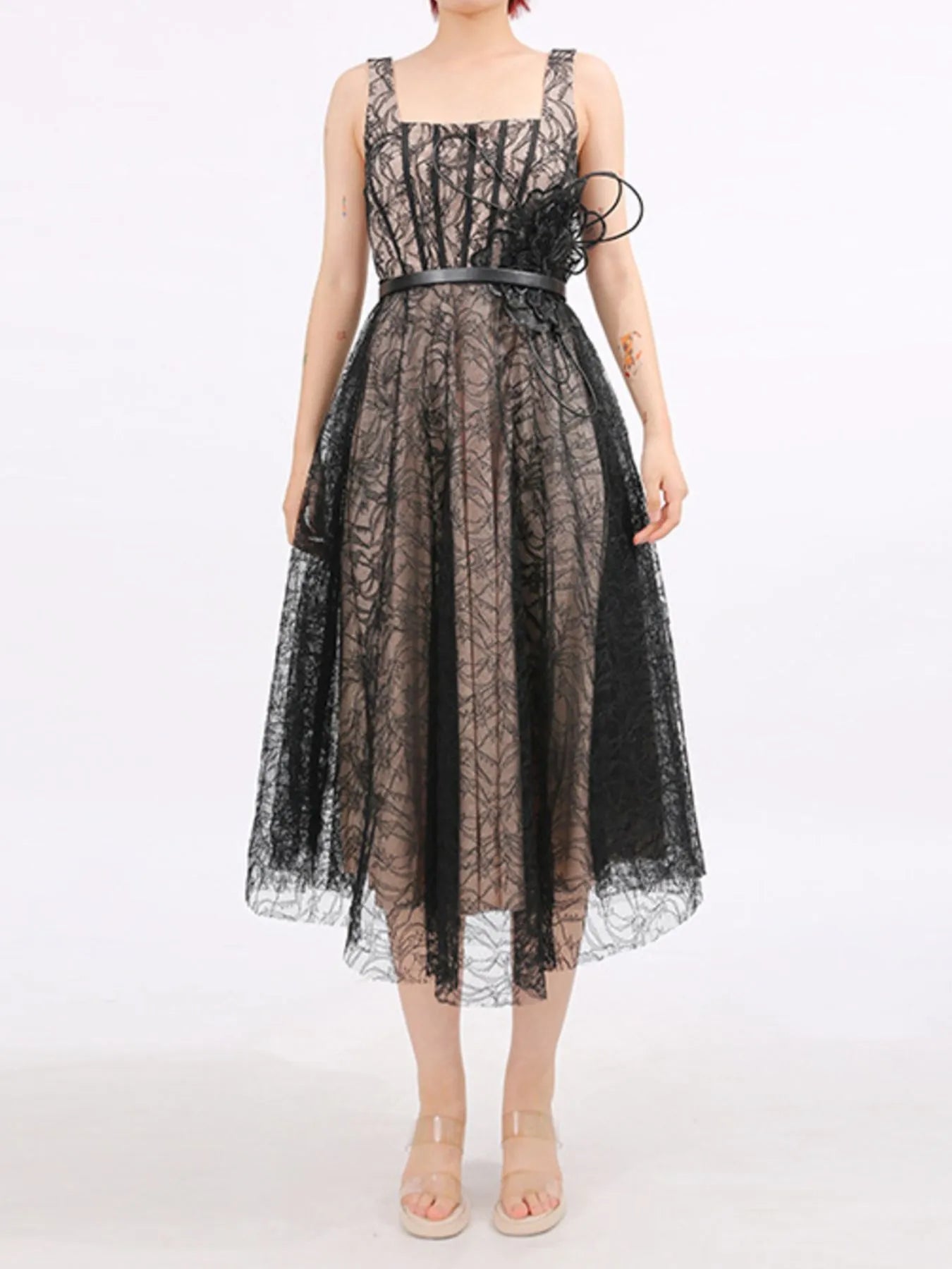 NEWYORKLISTED RUNWAY STYLE: Black lace dress worn by a model on a white background