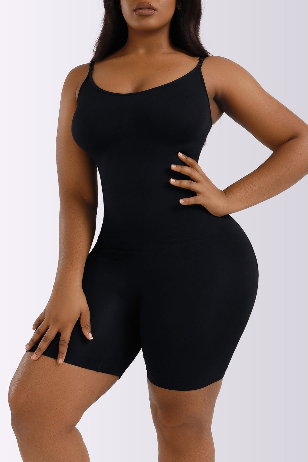 NEWYORKLISTED Intimate Apparel Collection: Person wearing a black bodysuit against a white background