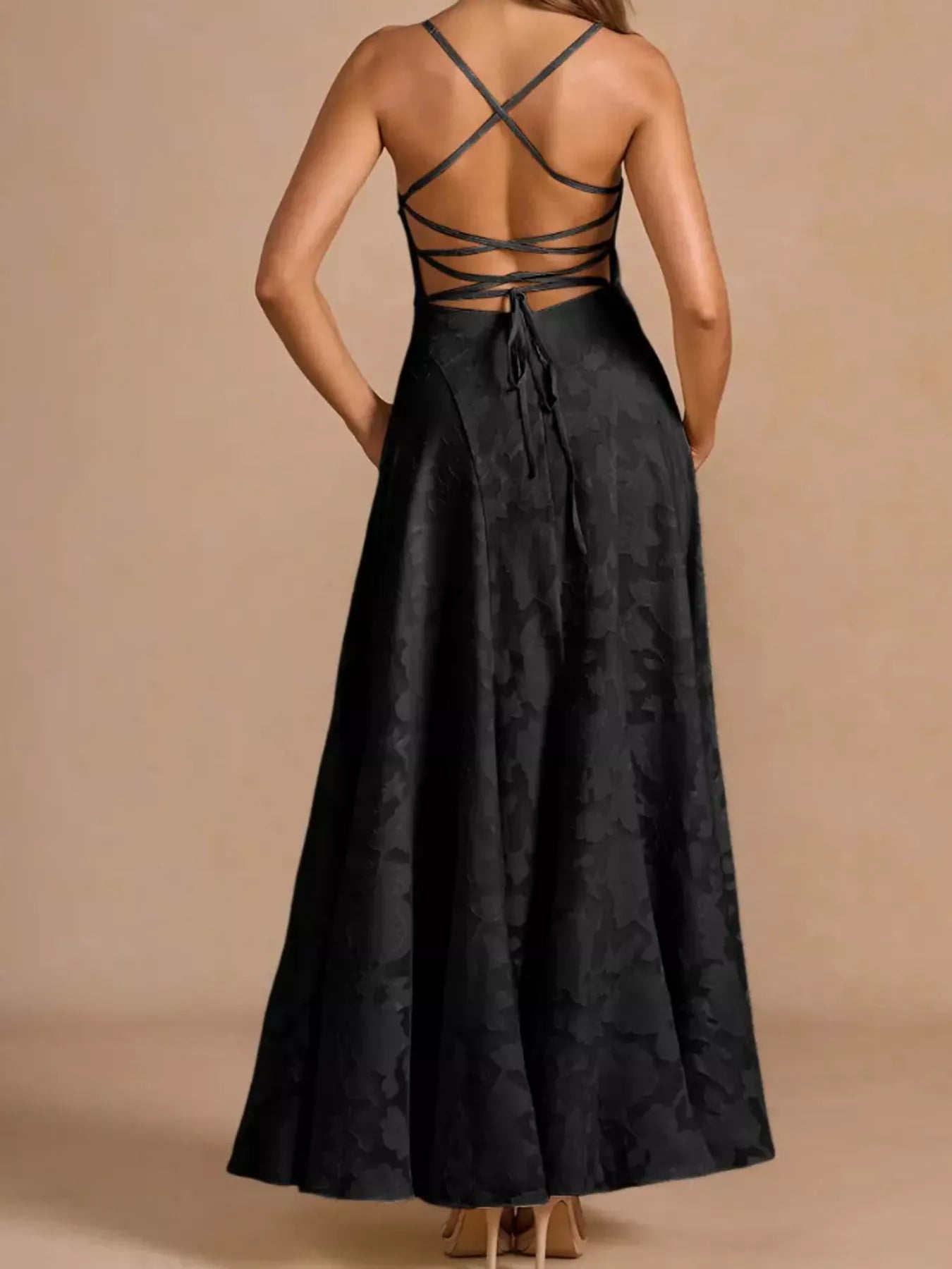 NEWYORKLISTED STYLE COLLECTION: Black dress with criss-cross back design on a beige background