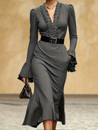 NEWYORKLISTED STYLE COLLECTION: Gray dress with ruffled details and a belt on a neutral background