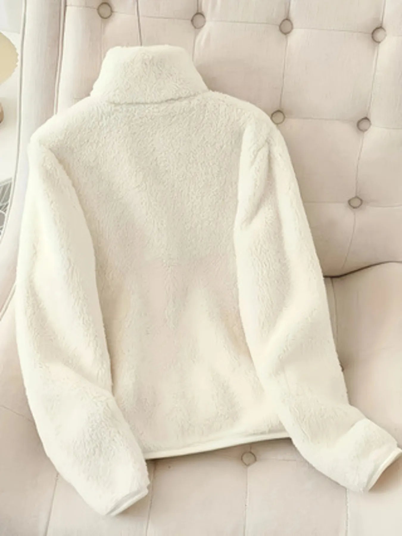 NEWYORKLISTED fleece zip-up jacket – women’s casual fashion on a beige upholstered chair