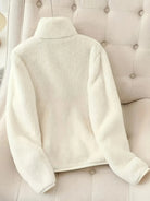 NEWYORKLISTED fleece zip-up jacket – women’s casual fashion on a beige upholstered chair