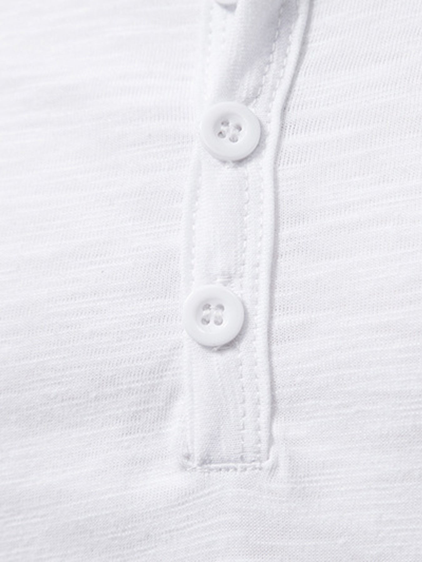 NEWYORKLISTED ATLAS MEN'S COLLECTION: Close-up of a white shirt with buttons on a white background