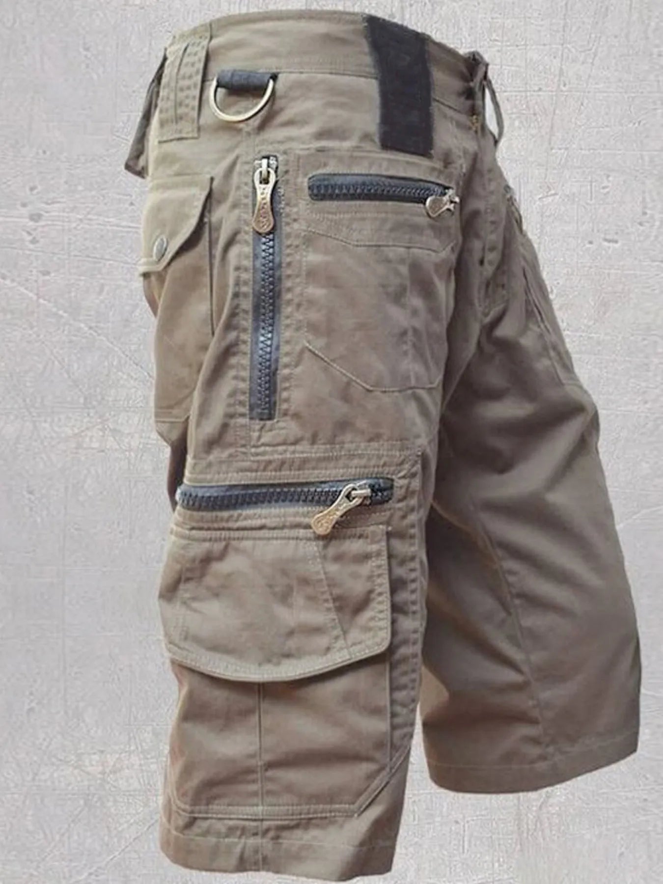 NEWYORKLISTED ATLAS MEN'S COLLECTION: Brown cargo shorts with multiple pockets and zippers on a light gray background