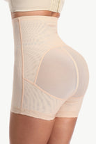 Beige shapewear garment on a white background