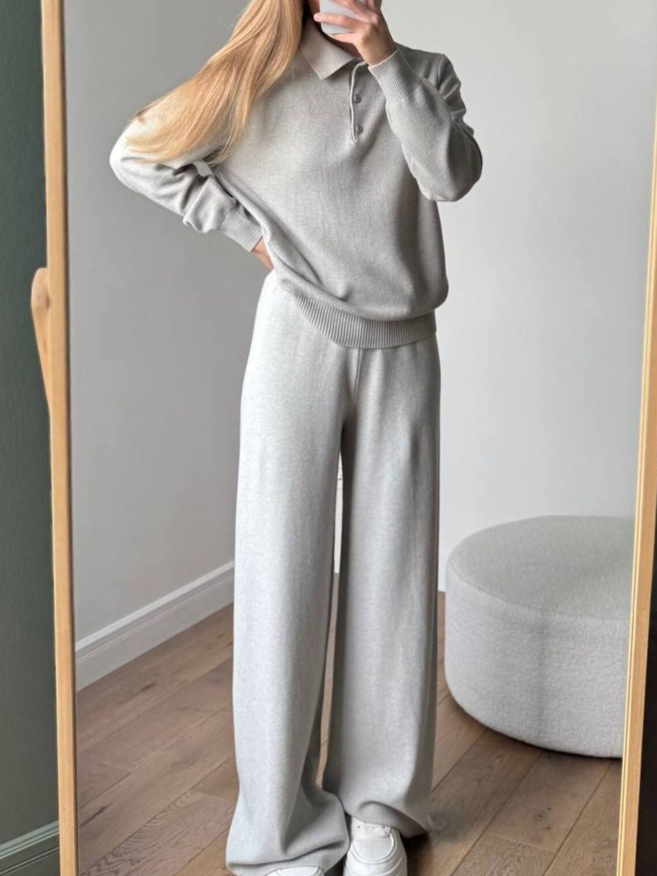NEWYORKLISTED Comfort Collection: Person wearing a gray sweater and pants standing in front of a mirror.