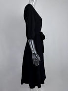 NEWYORKLISTED STYLE COLLECTION: Mannequin wearing a black dress with a metallic arm on a gray background