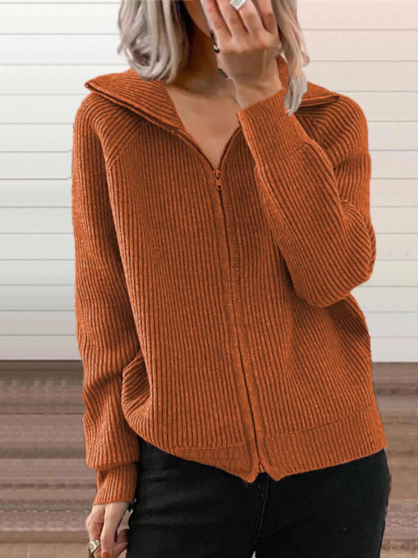 NEWYORKLISTED STYLE COLLECTION:Person wearing a brown ribbed sweater with a zipper against a neutral background