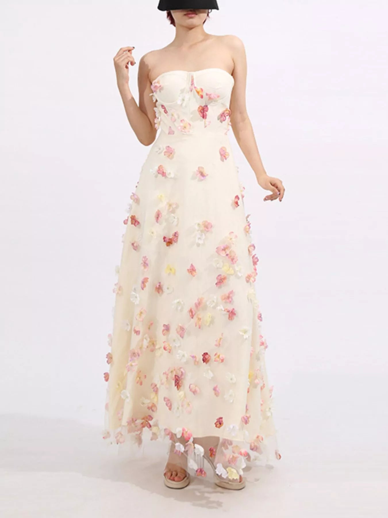 NEWYORKLISTED STYLE COLLECTION: Woman wearing a strapless floral gown on a white background