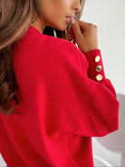 NEWYORKLISTED STYLE COLLECTION: Red sweater with gold buttons worn by a person, on a plain background