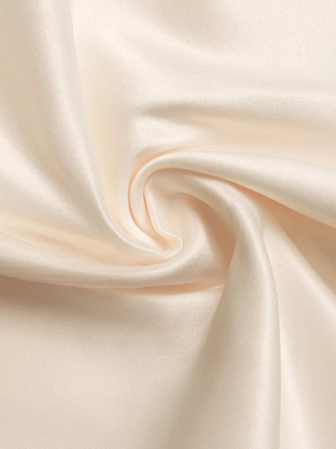 Close-up of smooth, beige fabric with folds