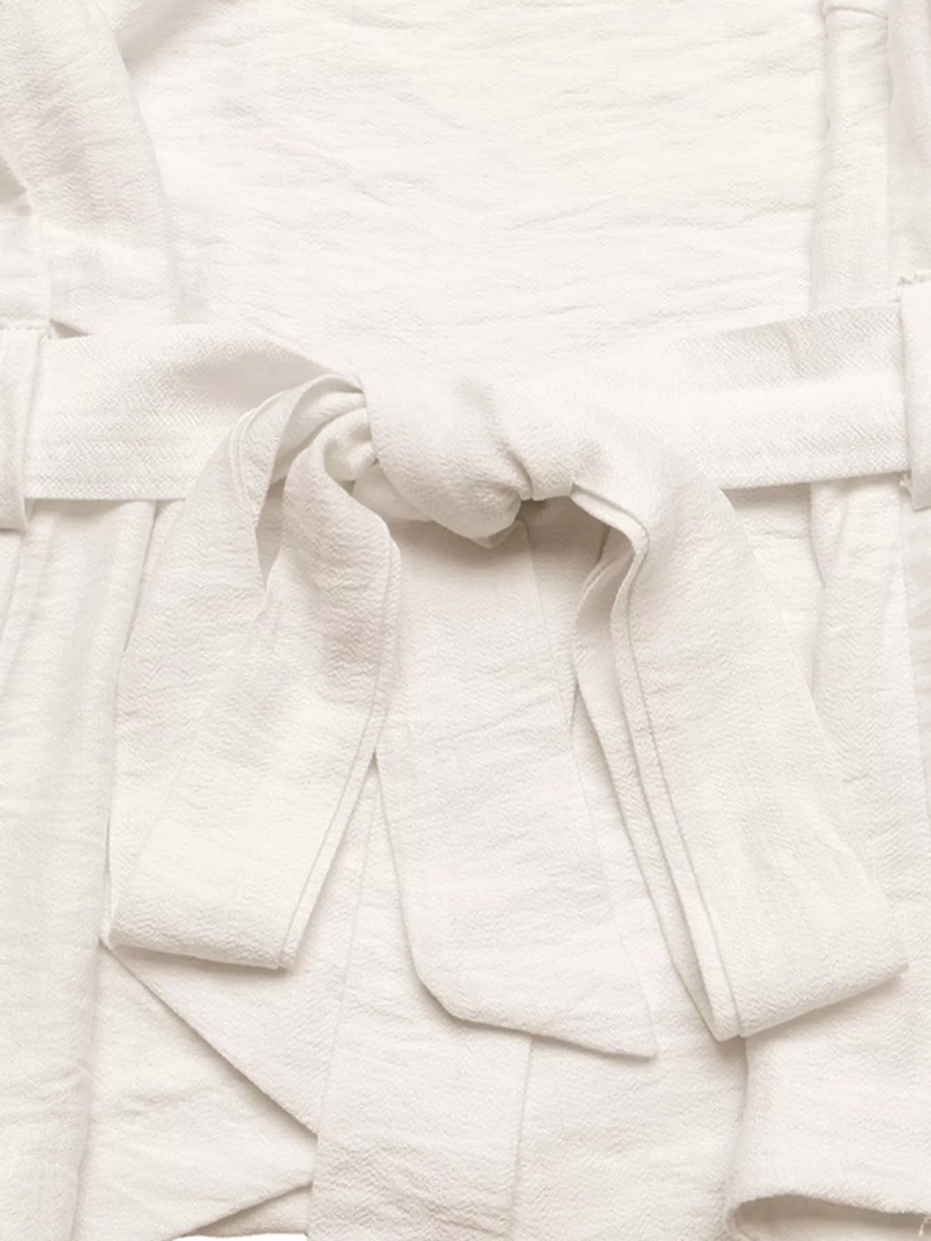 NEWYORKLISTED STYLE COLLECTION: Close-up of a white textured fabric with folds
