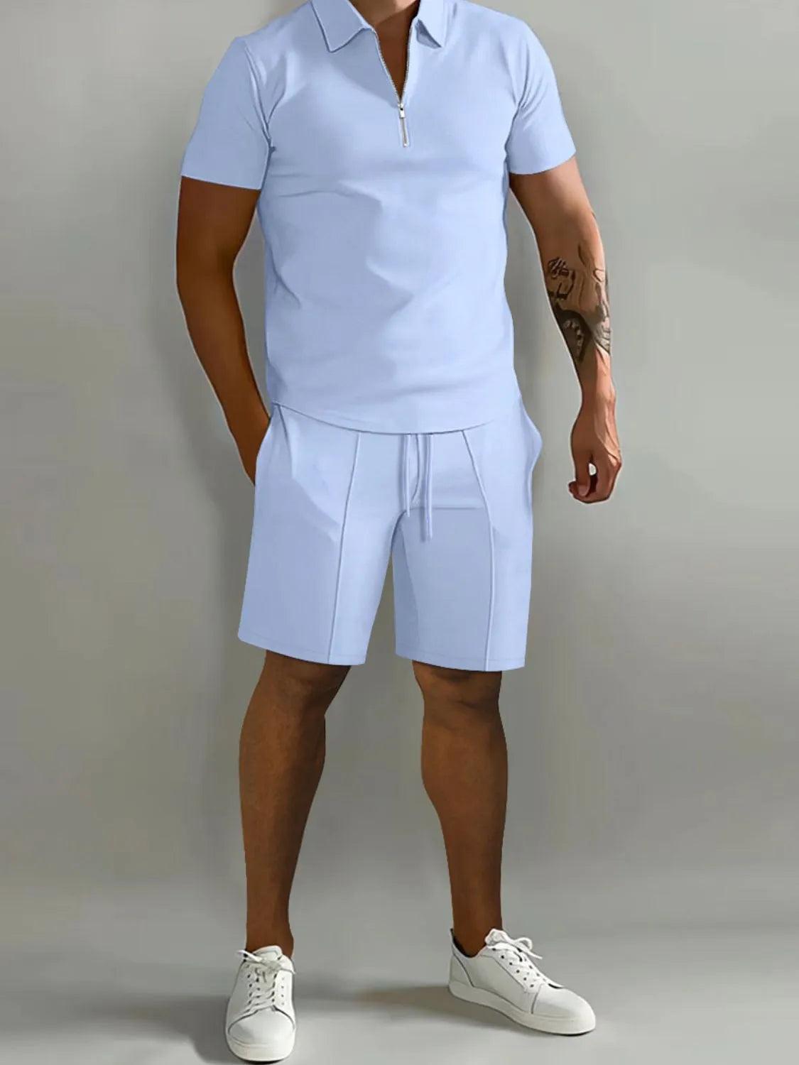 NEWYORKLISTED ATLAS MEN's COLLECTION: Person wearing a light blue polo shirt and shorts set with white sneakers on a plain background