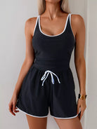 NEWYORKLISTED STYLE COLLECTION: Black tank top and shorts set with white trim on a plain background
