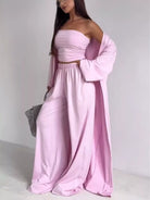 NEWYORKLISTED COMFORT COLLECTION: Woman wearing a pink outfit with a long cardigan on a white background