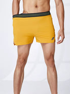 NEWYORKLISTED ATLAS MEN's COLLECTION: Yellow swim shorts with black waistband on a white background