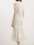 NEWYORKLISTED STYLE COLLECTION: White lace dress on a white background