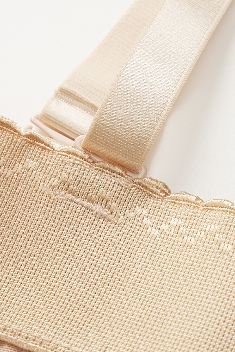 NEWYORKLISTED Intimate Apparel: Close-up of beige fabric with a strap on a white background